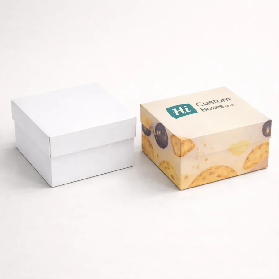 Two simple square biscuit boxes with lids- one plain white and one with a branded pattern- class=